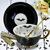 Black bat fortune telling teacup and saucer set with bat inside the teacup and also on the saucer.